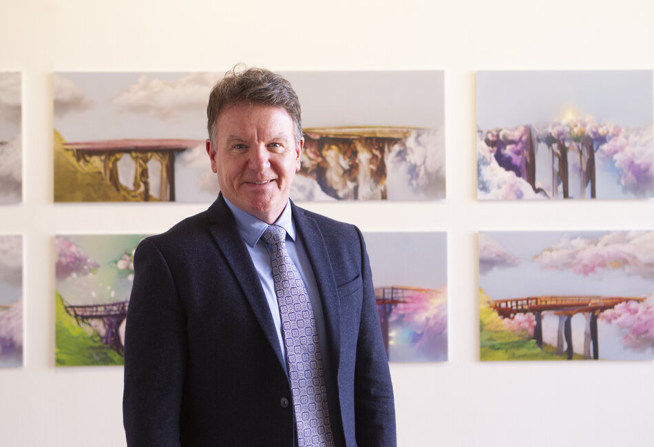 Sydney Catholic Schools' Executive Director, Tony Farley, stands in front of a winning Clancy Prize 2022 artwork