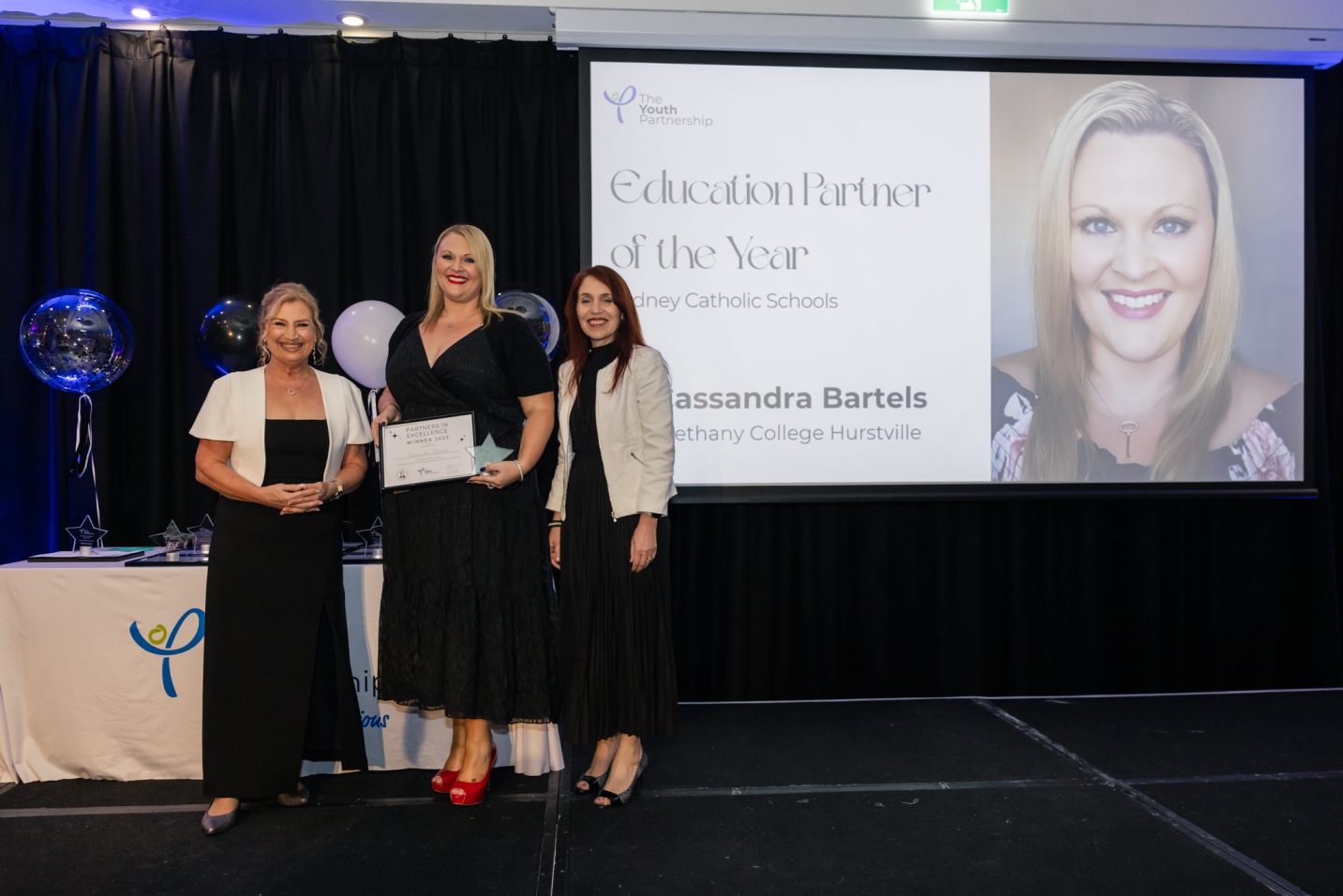 Photo of Cassie Bartels accepting her award at Partners in Excellence