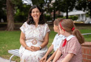 A photo showing Principal Kylie Brakel with two female students