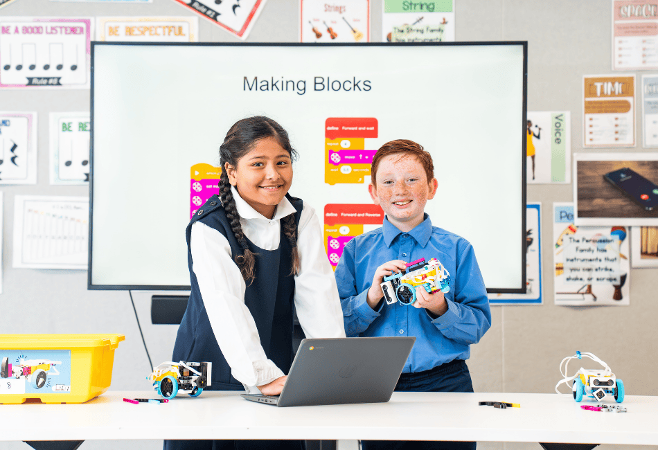A photo showing two students in a modern classroom learning about the wonders of STEM