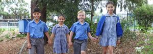 four primary students walking